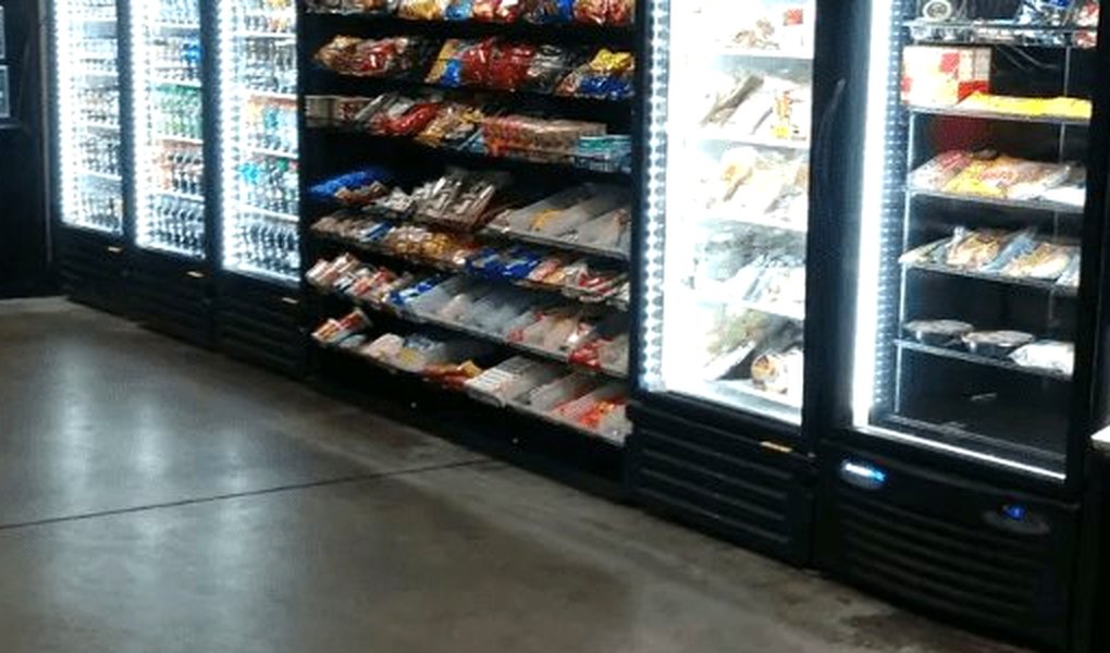 Stocked glass-door coolers and a snack rack in a break area